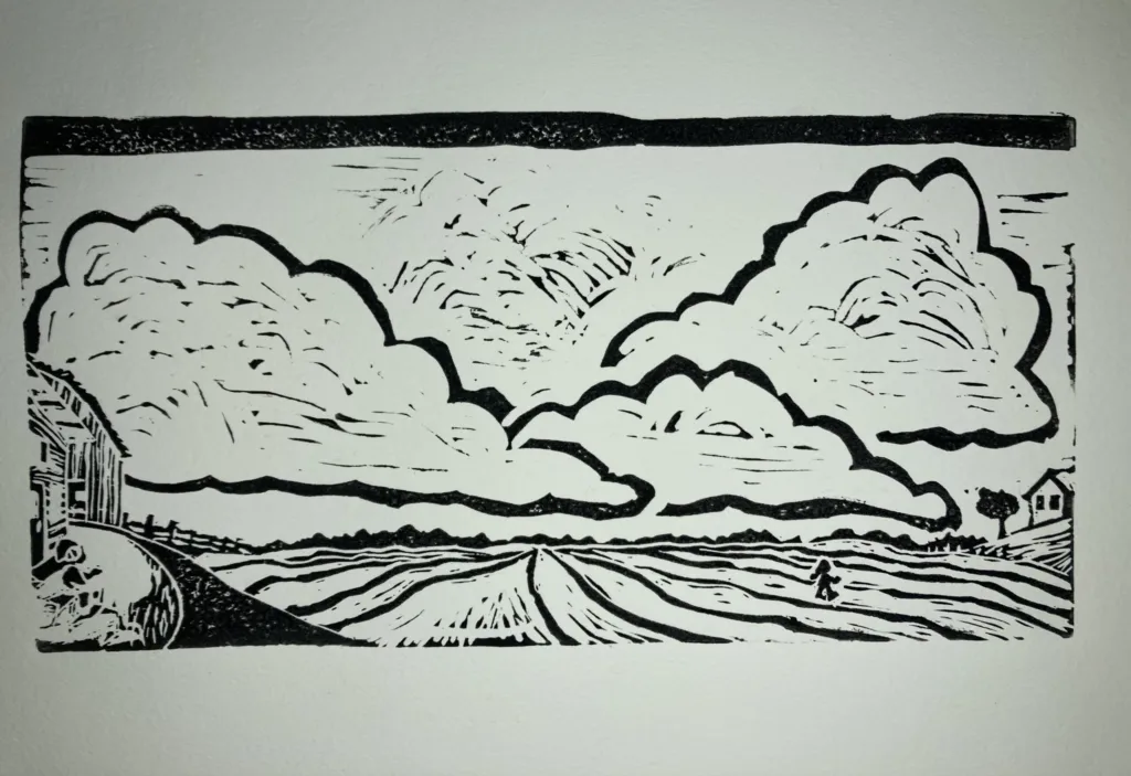 A woodcut of a field with clouds by Leigh Brownhill.